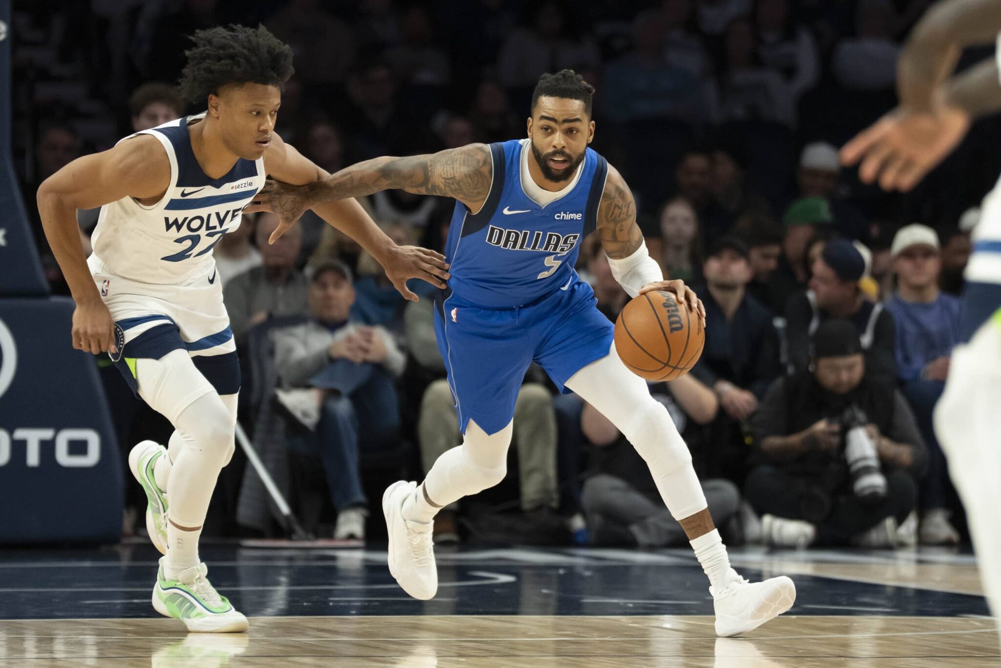 Dallas Mavericks guard D'Angelo Russell (5) dribbles the ball past Minnesota Timberwolves guard Jaylen Clark (22) in the first half at Target Center.
