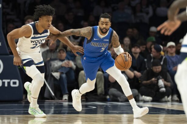 Dallas Mavericks guard D'Angelo Russell (5) dribbles the ball past Minnesota Timberwolves guard Jaylen Clark (22) in the first half at Target Center.