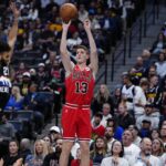 Nov 17, 2025; Denver, Colorado, USA; Chicago Bulls guard/forward Kevin Huerter (13) shoots the ball over Denver Nuggets guard Jamal Murray (27) in the first quarter at Ball Arena. Mandatory Credit: Ron Chenoy-Imagn Images
