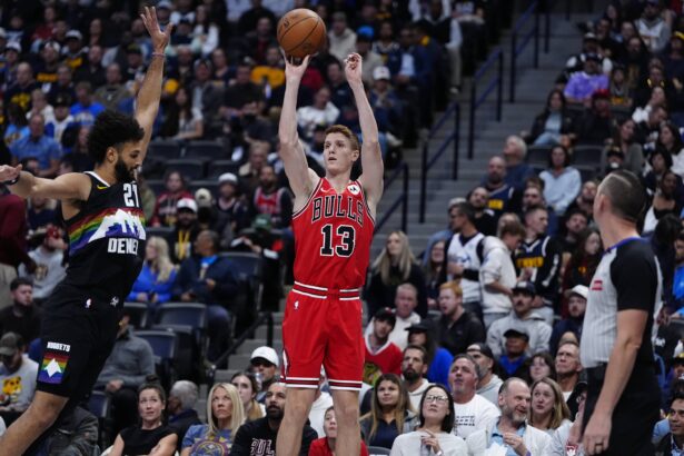 Nov 17, 2025; Denver, Colorado, USA; Chicago Bulls guard/forward Kevin Huerter (13) shoots the ball over Denver Nuggets guard Jamal Murray (27) in the first quarter at Ball Arena. Mandatory Credit: Ron Chenoy-Imagn Images