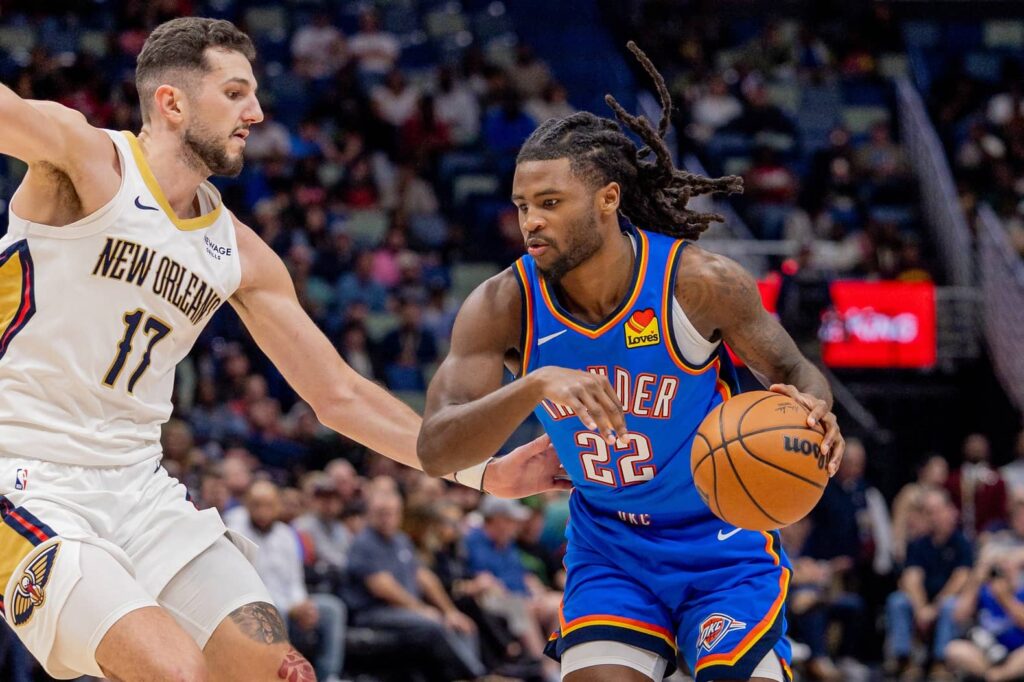Nov 17, 2025; New Orleans, Louisiana, USA; Oklahoma City Thunder guard Cason Wallace (22) dribbles against New Orleans Pelicans forward/center Karlo Matković (17) during the first half at Smoothie King Center. Mandatory Credit: Stephen Lew-Imagn Images