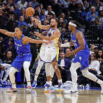 Nov 18, 2025; Orlando, Florida, USA; Golden State Warriors guard Stephen Curry (30) passes the ball over Orlando Magic guard Desmond Bane (3) during the first quarter at Kia Center. Mandatory Credit: Mike Watters-Imagn Images