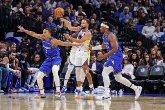 Nov 18, 2025; Orlando, Florida, USA; Golden State Warriors guard Stephen Curry (30) passes the ball over Orlando Magic guard Desmond Bane (3) during the first quarter at Kia Center. Mandatory Credit: Mike Watters-Imagn Images