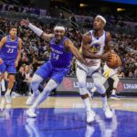 Nov 18, 2025; Orlando, Florida, USA; Golden State Warriors forward Jimmy Butler III (10) looks to shoot against Orlando Magic center Wendell Carter Jr. (34) during the second half at Kia Center. Mandatory Credit: Mike Watters-Imagn Images