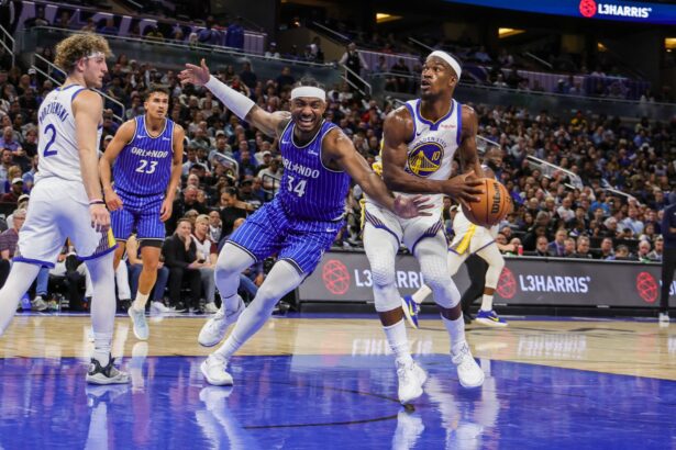 Nov 18, 2025; Orlando, Florida, USA; Golden State Warriors forward Jimmy Butler III (10) looks to shoot against Orlando Magic center Wendell Carter Jr. (34) during the second half at Kia Center. Mandatory Credit: Mike Watters-Imagn Images