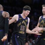 Nov 18, 2025; Los Angeles, California, USA; Los Angeles Lakers guard Austin Reaves (15) is congratulated by forward LeBron James (23) and guard Luka Doncic (77) after a three-point basket in the second quarter at Crypto.com Arena. Mandatory Credit: Kirby Lee-Imagn Images