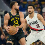 Nov 21, 2025; San Francisco, California, USA; Portland Trail Blazers forward Toumani Camara (33) defends against Golden State Warriors guard Stephen Curry (30) during the first quarter at Chase Center. Mandatory Credit: Robert Edwards-Imagn Images