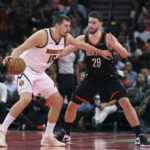 Nov 21, 2025; Houston, Texas, USA; Denver Nuggets center Nikola Jokic (15) controls the ball as Houston Rockets center Alperen Sengun (28) defends during the second quarter at Toyota Center. Mandatory Credit: Troy Taormina-Imagn Images