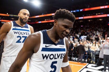 Nov 21, 2025; Phoenix, Arizona, USA; Minnesota Timberwolves guard Anthony Edwards (5) and center Rudy Gobert (27) react as they walk off the court after losing to the Phoenix Suns in the second half of an NBA Cup game at Mortgage Matchup Center. Mandatory Credit: Mark J. Rebilas-Imagn Images