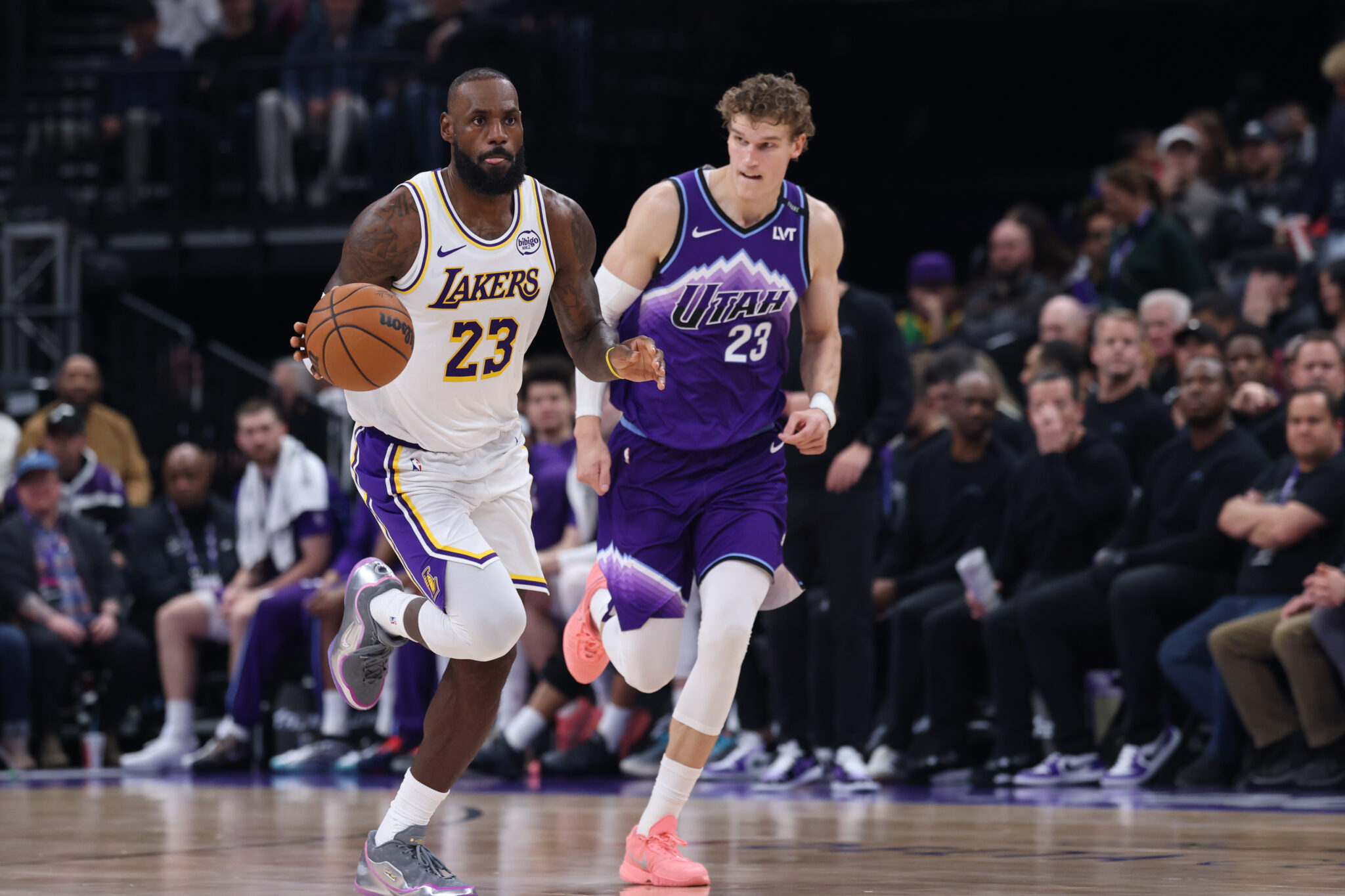 Nov 23, 2025; Salt Lake City, Utah, USA; Los Angeles Lakers forward LeBron James (23) brings the ball up the court against Utah Jazz forward Lauri Markkanen (23) during the second quarter at Delta Center. Mandatory Credit: Rob Gray-Imagn Images