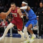 Nov 24, 2025; Miami, Florida, USA; Miami Heat guard Tyler Herro (14) drives to the basket as Dallas Mavericks guard Brandon Williams (10) defends during the first half at Kaseya Center. Mandatory Credit: Jim Rassol-Imagn Images
