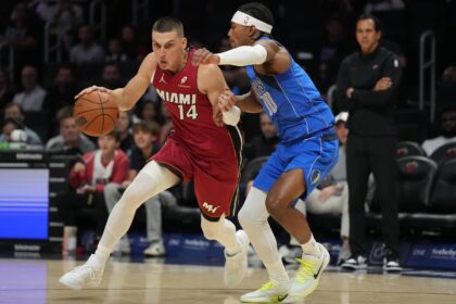 Nov 24, 2025; Miami, Florida, USA; Miami Heat guard Tyler Herro (14) drives to the basket as Dallas Mavericks guard Brandon Williams (10) defends during the first half at Kaseya Center. Mandatory Credit: Jim Rassol-Imagn Images