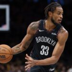 Nov 24, 2025; Brooklyn, New York, USA; Brooklyn Nets center Nic Claxton (33) dribbles during the second half against the New York Knicks at Barclays Center. Mandatory Credit: Vincent Carchietta-Imagn Images