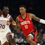 Nov 24, 2025; Phoenix, Arizona, USA; Phoenix Suns forward Rasheer Fleming (20) defends against Houston Rockets forward Jabari Smith Jr. (10) in the first half at Mortgage Matchup Center. Mandatory Credit: Mark J. Rebilas-Imagn Images