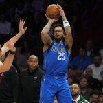 Nov 24, 2025; Miami, Florida, USA; Dallas Mavericks forward P.J. Washington (25) takes a shot over Miami Heat forward Jaime Jaquez Jr. (11) during the second half at Kaseya Center. Mandatory Credit: Jim Rassol-Imagn Images