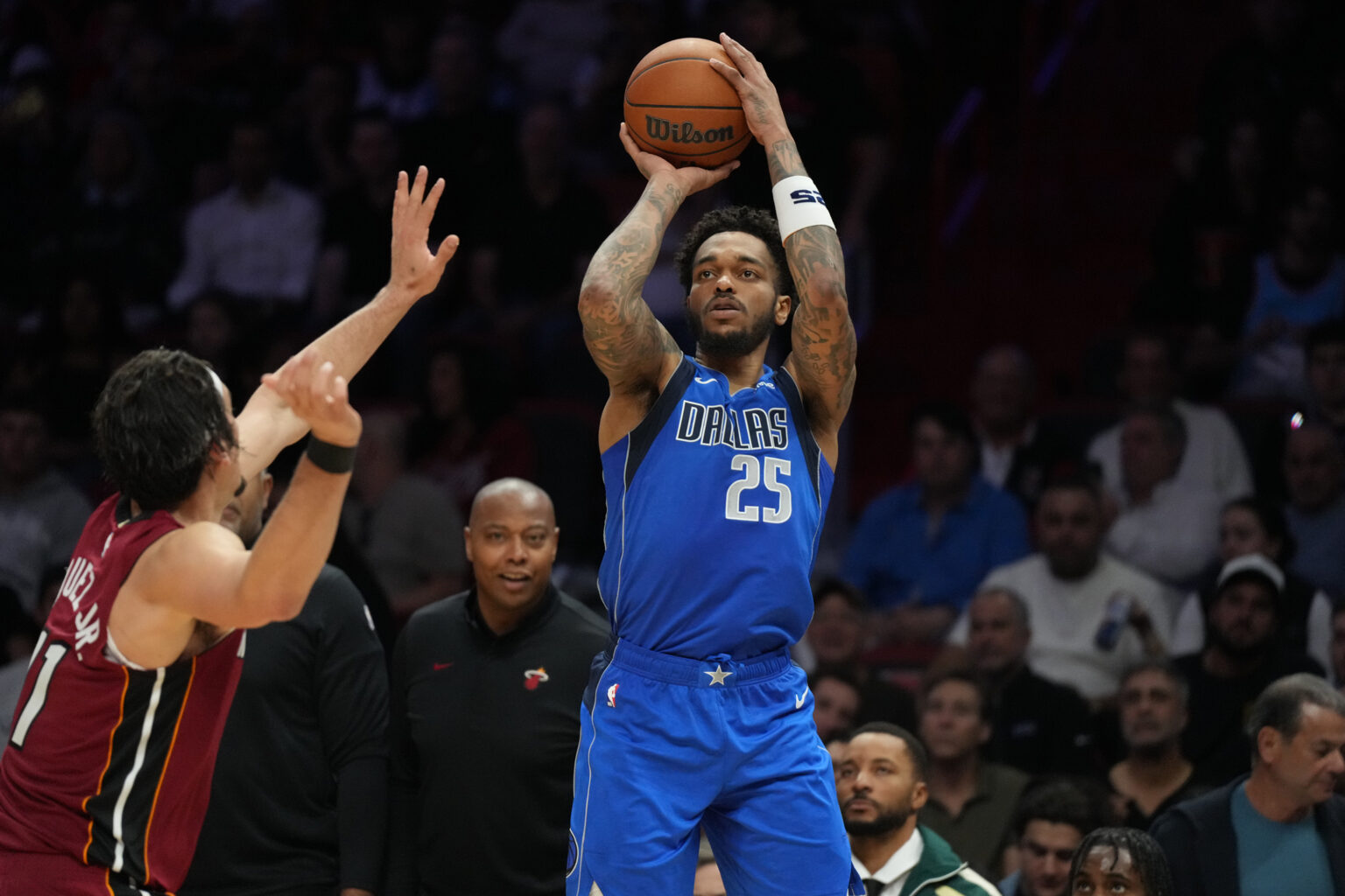 Nov 24, 2025; Miami, Florida, USA; Dallas Mavericks forward P.J. Washington (25) takes a shot over Miami Heat forward Jaime Jaquez Jr. (11) during the second half at Kaseya Center. Mandatory Credit: Jim Rassol-Imagn Images