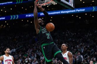 Nov 26, 2025; Boston, Massachusetts, USA; Boston Celtics guard Jaylen Brown (7) makes the basket against the Detroit Pistons in the second half at TD Garden. Mandatory Credit: David Butler II-Imagn Images