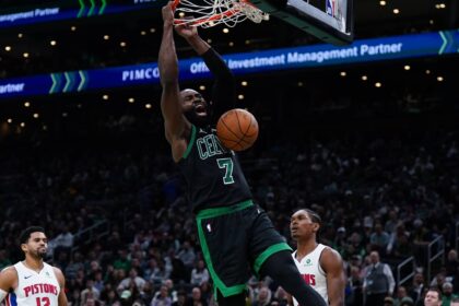 Nov 26, 2025; Boston, Massachusetts, USA; Boston Celtics guard Jaylen Brown (7) makes the basket against the Detroit Pistons in the second half at TD Garden. Mandatory Credit: David Butler II-Imagn Images