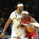 Nov 26, 2025; Miami, Florida, USA; Milwaukee Bucks center Myles Turner (3) defends Miami Heat center Bam Adebayo (13) during the first half of an NBA Cup game at Kaseya Center. Mandatory Credit: Rhona Wise-Imagn Images