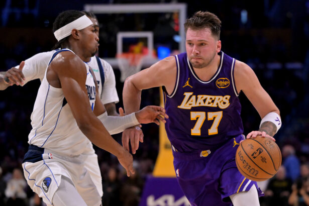 Nov 28, 2025; Los Angeles, California, USA; Los Angeles Lakers guard Luka Doncic (77) is defended by Dallas Mavericks guard Brandon Williams (10) as he drives to the basket in the first half at Crypto.com Arena. Mandatory Credit: Jayne Kamin-Oncea-Imagn Images