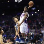 Oct 17, 2025; Philadelphia, Pennsylvania, USA; Philadelphia 76ers guard Vj Edgecombe (77) is fouled by Minnesota Timberwolves guard Jules Bernard (14) while driving for a dunk during the fourth quarter at Xfinity Mobile Arena. Mandatory Credit: Bill Streicher-Imagn Images