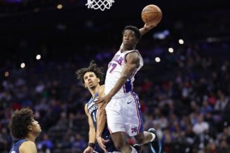 Oct 17, 2025; Philadelphia, Pennsylvania, USA; Philadelphia 76ers guard Vj Edgecombe (77) is fouled by Minnesota Timberwolves guard Jules Bernard (14) while driving for a dunk during the fourth quarter at Xfinity Mobile Arena. Mandatory Credit: Bill Streicher-Imagn Images