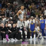 Nov 14, 2025; San Antonio, Texas, USA; San Antonio Spurs forward Victor Wembanyama (1) gets back on defense after scoring a three-point basket during the second half against the Golden State Warriors at Frost Bank Center. Mandatory Credit: Scott Wachter-Imagn Images
