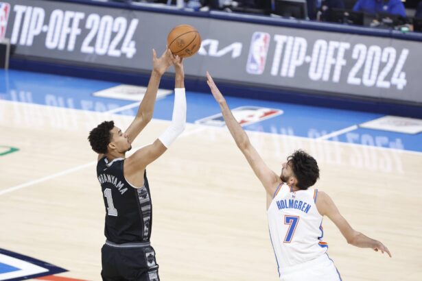 Oct 30, 2024; Oklahoma City, Oklahoma, USA; San Antonio Spurs center Victor Wembanyama (1) shoots as Oklahoma City Thunder forward Chet Holmgren (7) defends during the first quarter at Paycom Center. Mandatory Credit: Alonzo Adams-Imagn Images
