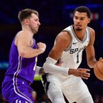 San Antonio Spurs forward Victor Wembanyama (1) moves the ball against Los Angeles Lakers guard Luka Doncic (77) during the second half at Crypto.com Arena.