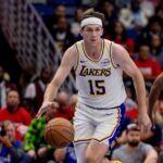 New Orleans, Louisiana, USA; Los Angeles Lakers guard Austin Reaves (15) brings the ball up court against the New Orleans Pelicans during the first half at Smoothie King Center. Mandatory Credit: Stephen Lew-Imagn Images
