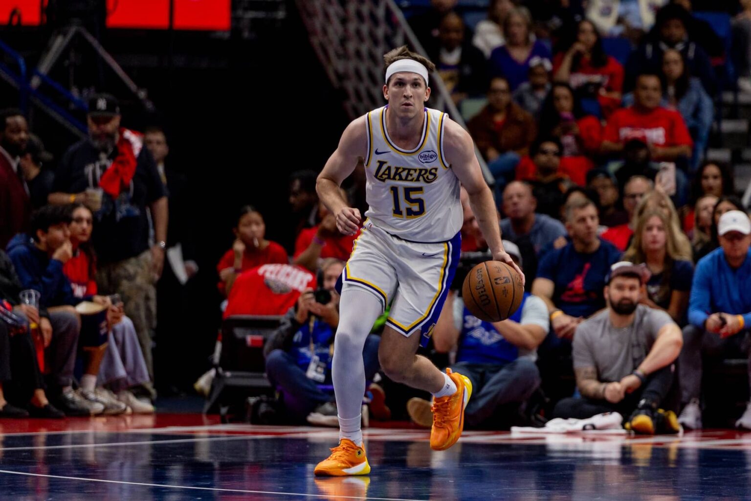 New Orleans, Louisiana, USA; Los Angeles Lakers guard Austin Reaves (15) brings the ball up court against the New Orleans Pelicans during the first half at Smoothie King Center. Mandatory Credit: Stephen Lew-Imagn Images
