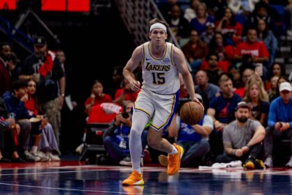 New Orleans, Louisiana, USA; Los Angeles Lakers guard Austin Reaves (15) brings the ball up court against the New Orleans Pelicans during the first half at Smoothie King Center. Mandatory Credit: Stephen Lew-Imagn Images