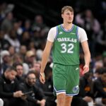 Dallas, Texas, USA; Dallas Mavericks forward Cooper Flagg (32) walks back up the court during the second half against the Phoenix Suns at the American Airlines Center. Mandatory Credit: Jerome Miron-Imagn Images