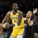 Minneapolis, Minnesota, USA; Los Angeles Lakers center Deandre Ayton (5) looks to pass the ball as Minnesota Timberwolves guard Donte DiVincenzo (0) plays defense in the first half at Target Center. Mandatory Credit: Jesse Johnson-Imagn Images
