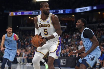 Memphis, Tennessee, USA; Los Angeles Lakers center Deandre Ayton (5) spins to the basket as Memphis Grizzlies forward Vince Williams Jr. (5) defends during the second quarter at FedExForum. Mandatory Credit: Petre Thomas-Imagn Images