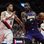 Portland, Oregon, USA; Los Angeles Lakers center Deandre Ayton (5) drives to the basket during the second half against Portland Trail Blazers forward Toumani Camara (33) at Moda Center. Mandatory Credit: Troy Wayrynen-Imagn Images