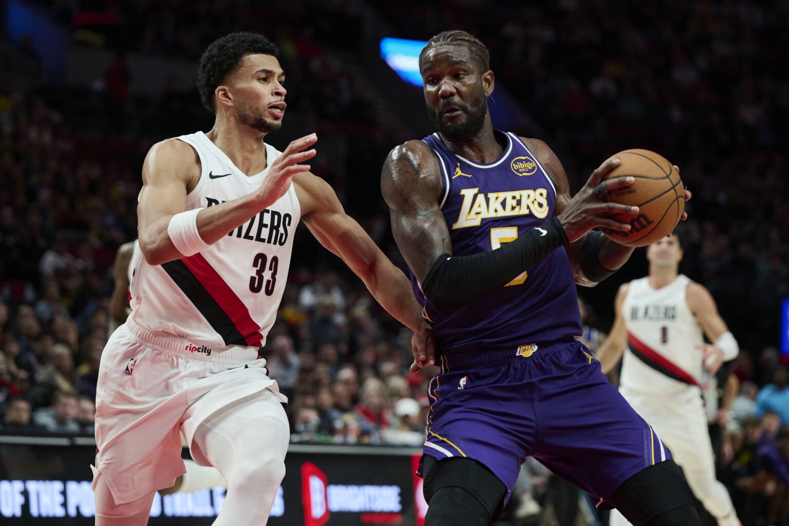 Portland, Oregon, USA; Los Angeles Lakers center Deandre Ayton (5) drives to the basket during the second half against Portland Trail Blazers forward Toumani Camara (33) at Moda Center. Mandatory Credit: Troy Wayrynen-Imagn Images