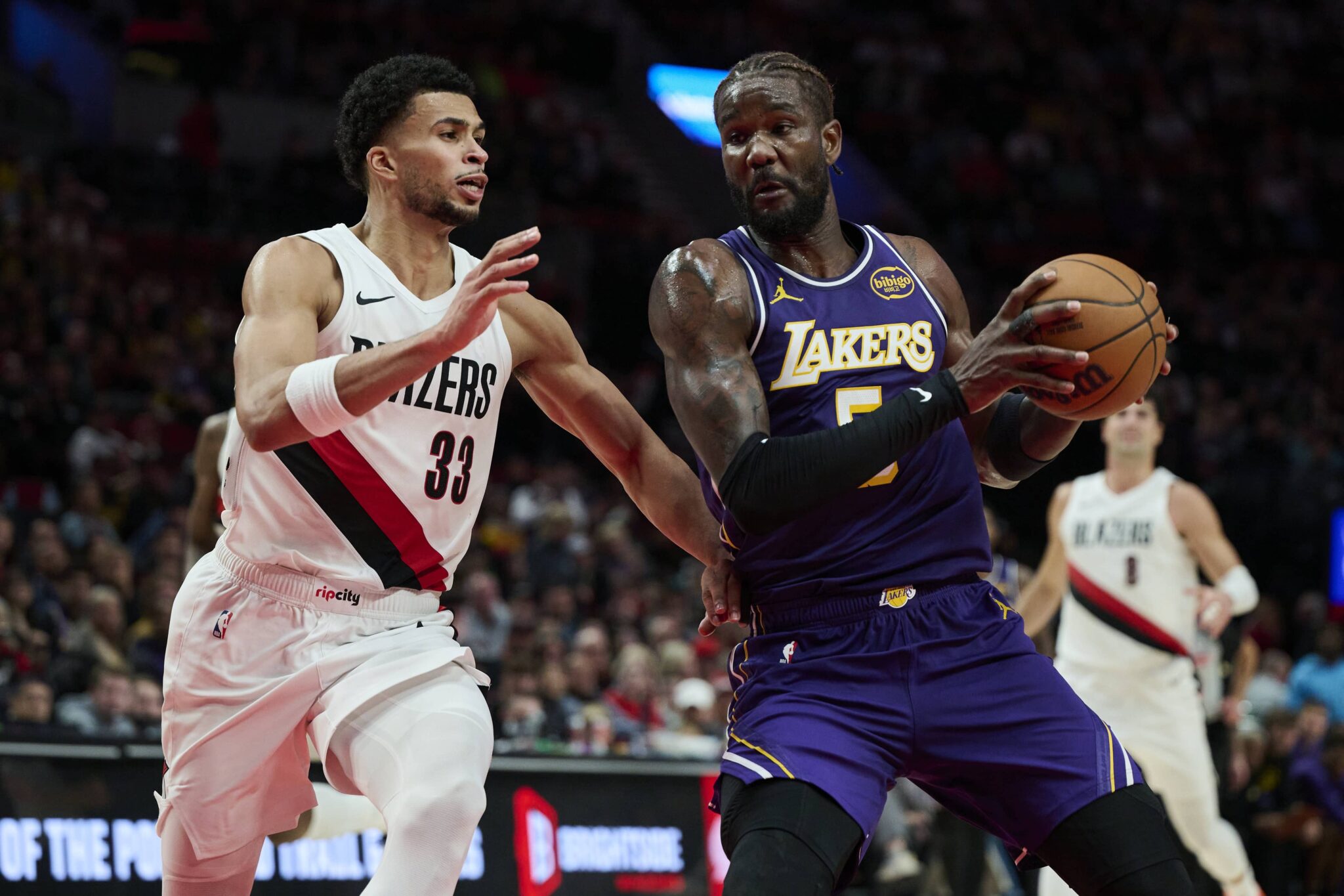 Portland, Oregon, USA; Los Angeles Lakers center Deandre Ayton (5) drives to the basket during the second half against Portland Trail Blazers forward Toumani Camara (33) at Moda Center. Mandatory Credit: Troy Wayrynen-Imagn Images
