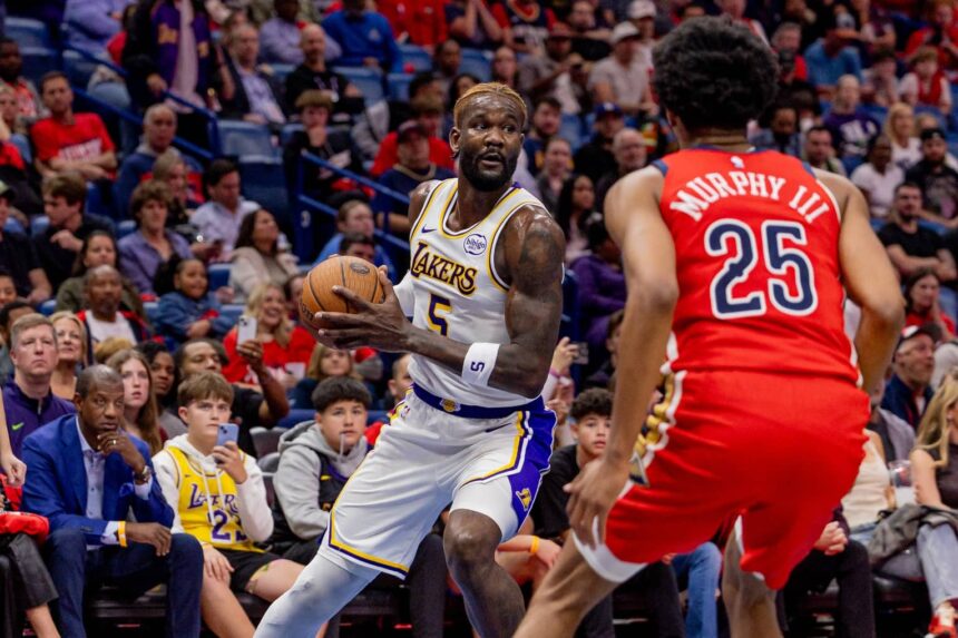 New Orleans, Louisiana, USA; Los Angeles Lakers center Deandre Ayton (5) dribbles against New Orleans Pelicans forward Trey Murphy III (25) during the first half at Smoothie King Center. Mandatory Credit: Stephen Lew-Imagn Images
