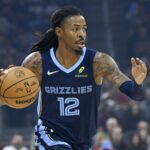 Cleveland, Ohio, USA; Memphis Grizzlies guard Ja Morant (12) dribbles the ball in the first quarter against the Cleveland Cavaliers at Rocket Arena. Mandatory Credit: David Richard-Imagn Images