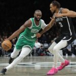 Brooklyn, New York, USA; Boston Celtics guard Jaylen Brown (7) brings the ball up court against Brooklyn Nets center Nic Claxton (33) during the second quarter at Barclays Center. Mandatory Credit: Brad Penner-Imagn Images