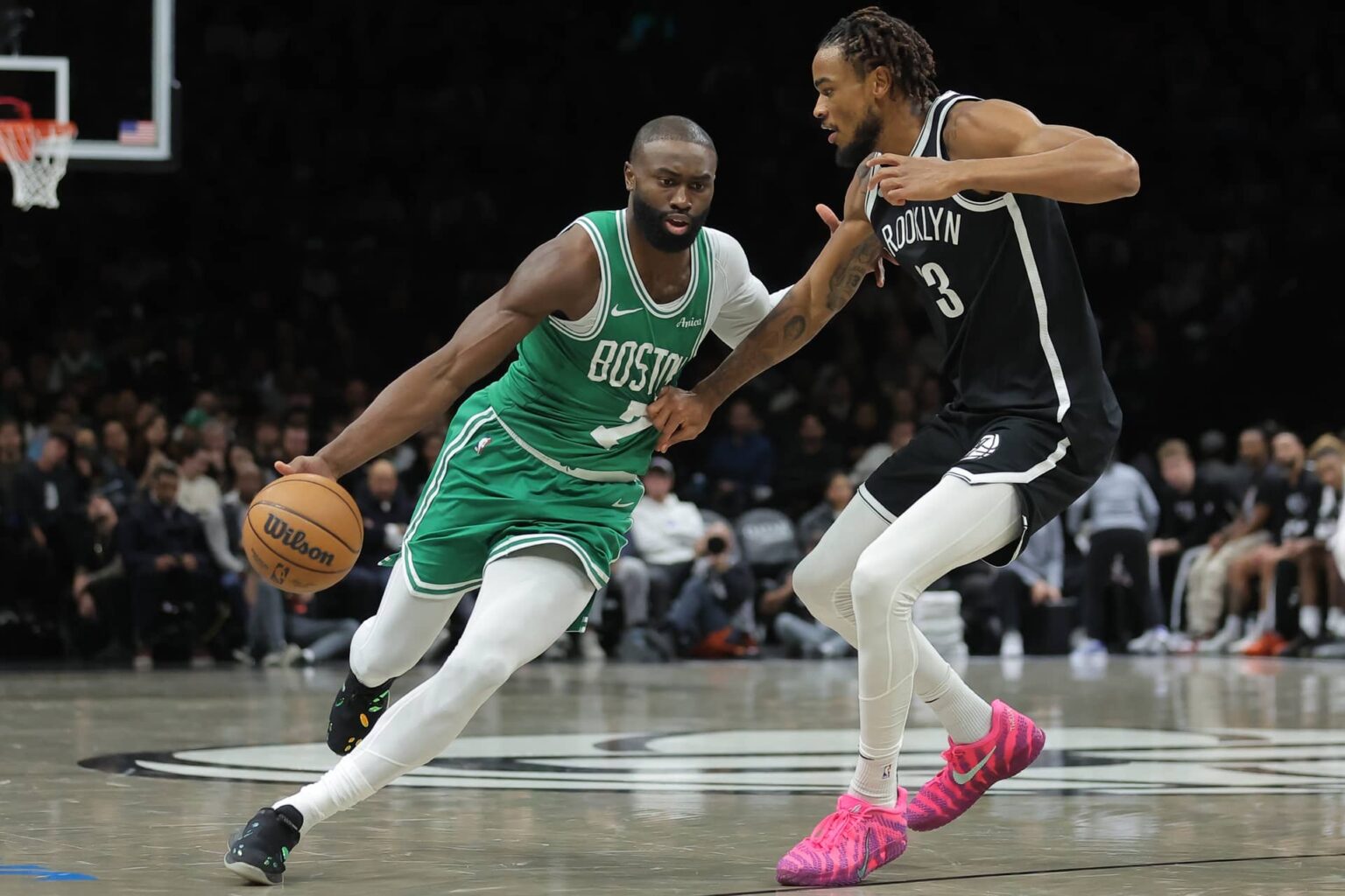 Brooklyn, New York, USA; Boston Celtics guard Jaylen Brown (7) brings the ball up court against Brooklyn Nets center Nic Claxton (33) during the second quarter at Barclays Center. Mandatory Credit: Brad Penner-Imagn Images