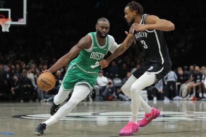 Brooklyn, New York, USA; Boston Celtics guard Jaylen Brown (7) brings the ball up court against Brooklyn Nets center Nic Claxton (33) during the second quarter at Barclays Center. Mandatory Credit: Brad Penner-Imagn Images