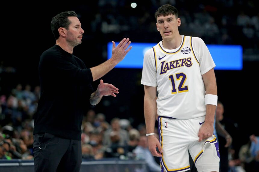 Memphis, Tennessee, USA; Los Angeles Lakers head coach JJ Redick talks with forward Jake LaRavia (12) during the first quarter against the Memphis Grizzlies at FedExForum. Mandatory Credit: Petre Thomas-Imagn Images
