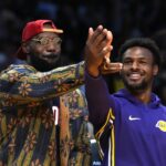 Los Angeles, California, USA; Los Angeles Lakers forward LeBron James (left) and son Bronny James watch from the bench in the second half against the Minnesota Timberwolves at Crypto.com Arena. Mandatory Credit: Kirby Lee-Imagn Images