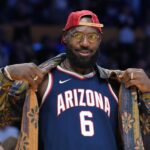 Los Angeles, California, USA; Los Angeles Lakers forward LeBron James poses in the Arizona Wildcats jersey of his son Bryce James (6) during the game against the Minnesota Timberwolves at Crypto.com Arena. Mandatory Credit: Kirby Lee-Imagn Images