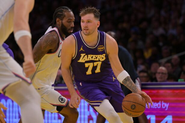 Los Angeles, California, USA; Los Angeles Lakers guard Luka Doncic (77) drives past Los Angeles Clippers forward Kawhi Leonard (2) during the first half at Crypto.com Arena. Mandatory Credit: Jayne Kamin-Oncea-Imagn Images