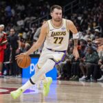 Atlanta, Georgia, USA; Los Angeles Lakers guard Luka Doncic (77) dribbles against the Atlanta Hawks during the first half at State Farm Arena. Mandatory Credit: Dale Zanine-Imagn Images