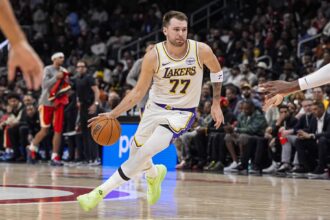 Atlanta, Georgia, USA; Los Angeles Lakers guard Luka Doncic (77) dribbles against the Atlanta Hawks during the first half at State Farm Arena. Mandatory Credit: Dale Zanine-Imagn Images