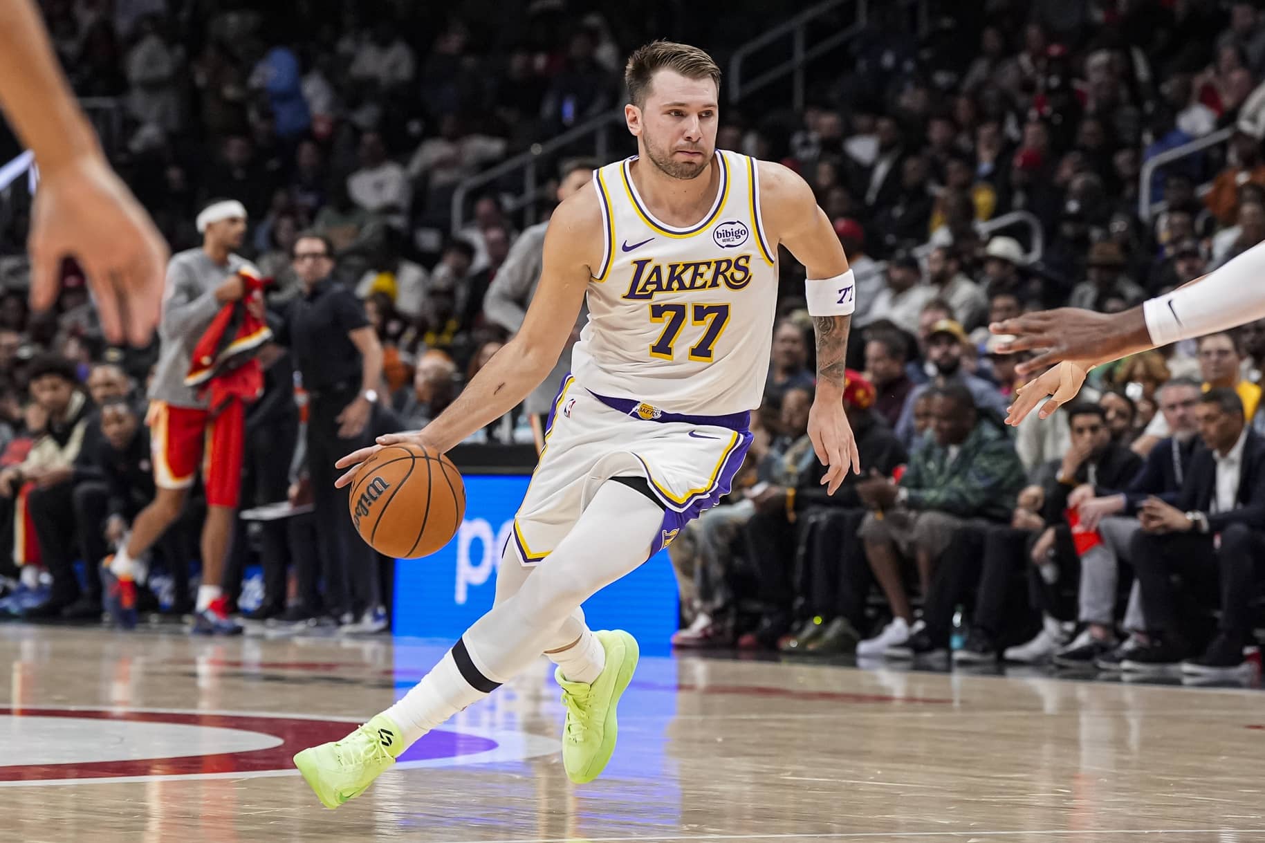 Atlanta, Georgia, USA; Los Angeles Lakers guard Luka Doncic (77) dribbles against the Atlanta Hawks during the first half at State Farm Arena. Mandatory Credit: Dale Zanine-Imagn Images
